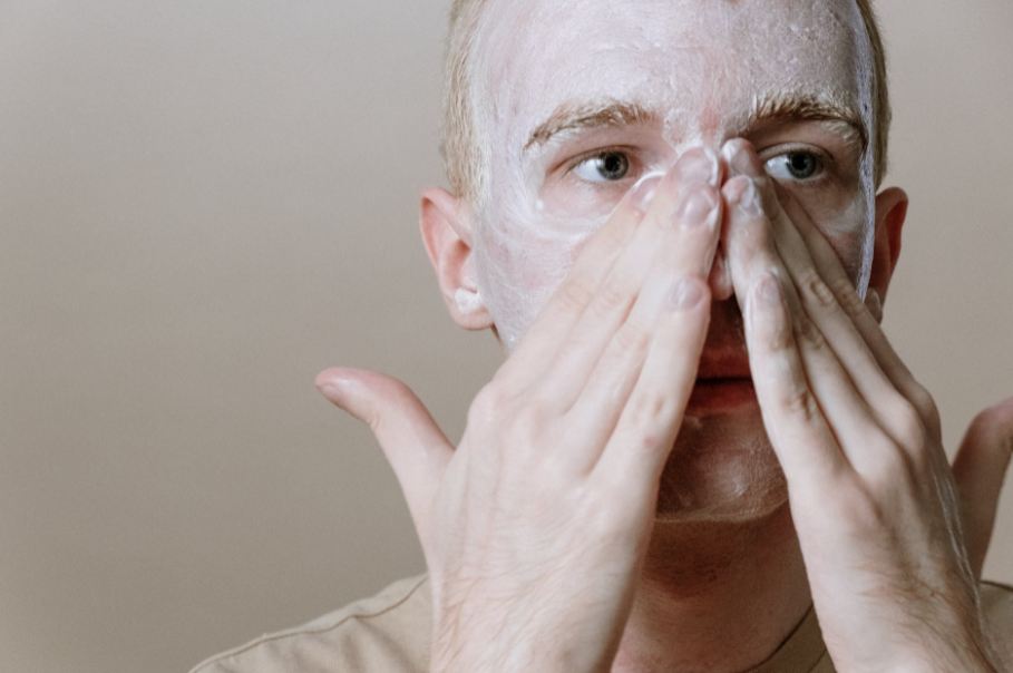 man-in-white-shirt-covering-face-with-white-textile