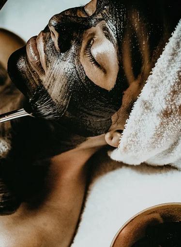A woman laying with a black mask