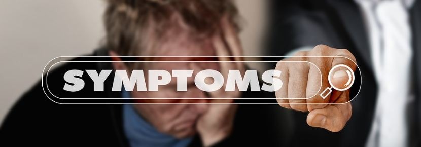 A man pointing towards symptoms written on a transparent sheet
