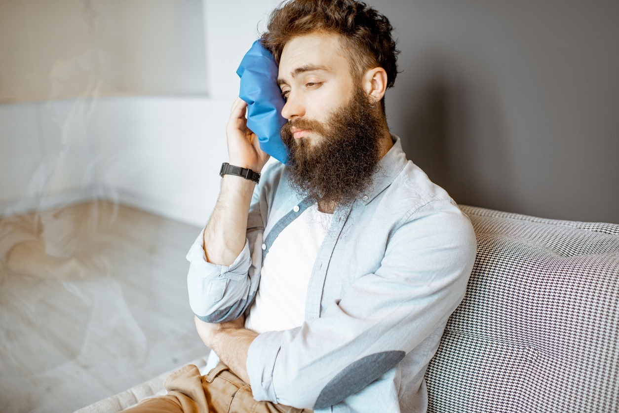 Man with headache at home