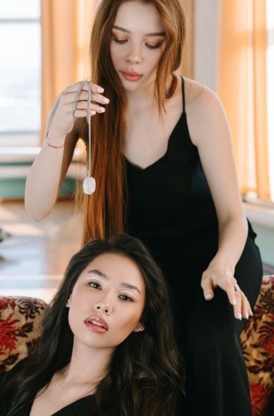 a woman hypnotizing another woman