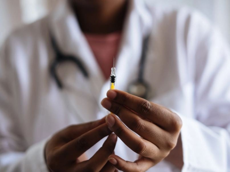 a doctor holding an injection