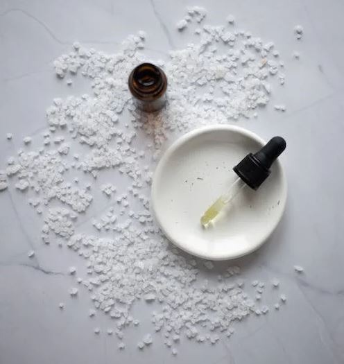 salt with oil placed on plate on marble table