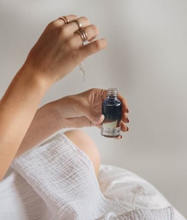 feminine hand using skincare product