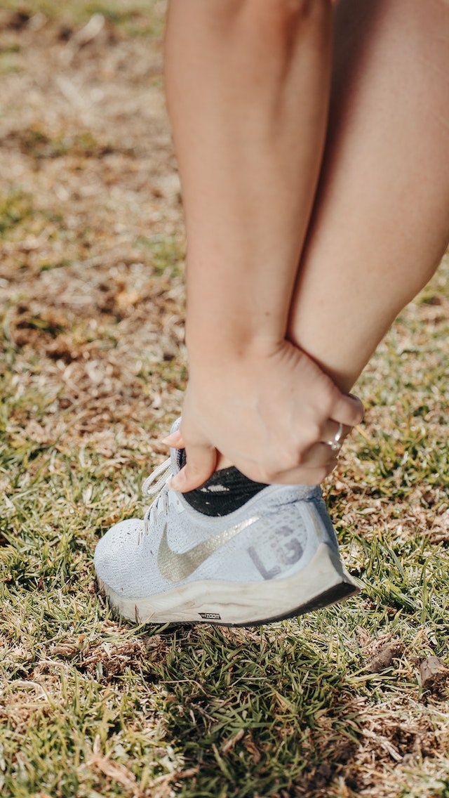 A person holding his ankle
