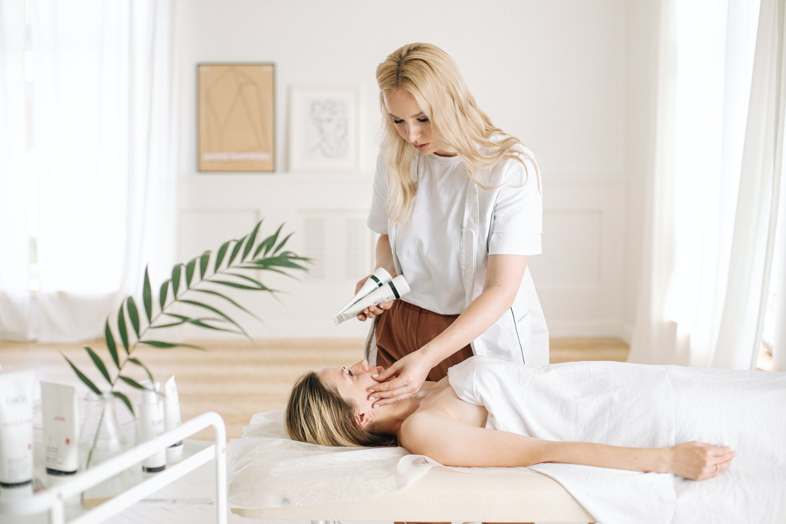 a dermatologist checking the client’s face