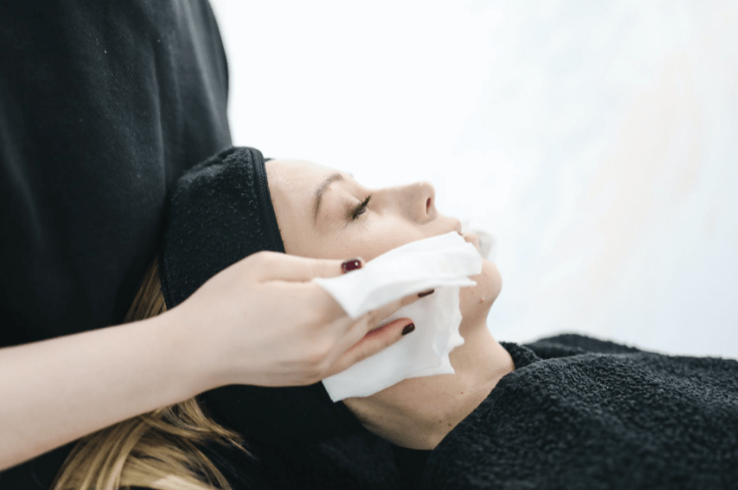 photo-of-person-using-a-tissue-to-dry-a-woman-s-face