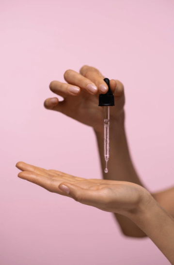 person-holding-a-dropper-with-liquid